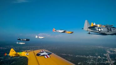 View of vintage airplanes flying formation from one of the formation airplanes