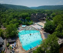 Arial picture looking down on Crystal Pool at Knoebels Amusement Resort with the Twister Roller Coaster in the background.