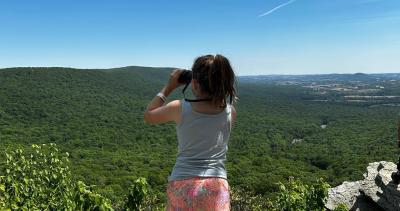 Child looking through binoculars at Hawk Mountain