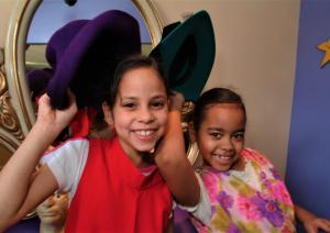 Two young girls playing dress-up at Fayetteville's Fascinate-U Children's Museum