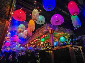 The inside of lava & Tonic is illuminated by colorful lamps suspended from the ceiling