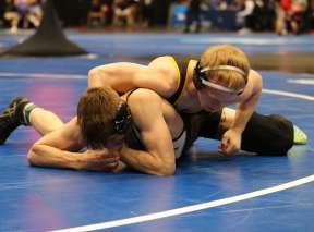 Two college men wrestle during an NCAA Men's Wrestling match at Park City Arena.