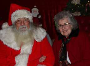 A man and woman are dresses as Stanta and Mrs. Claus at Watson's Christmas Express