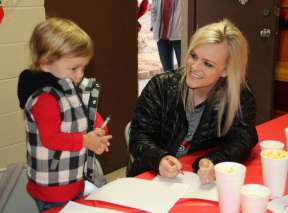 A woman and a small child enjoy making crafts at Watson's Christmas Express