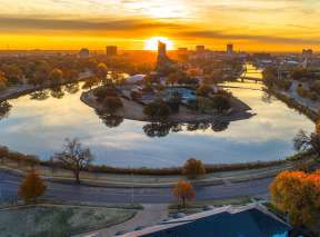 A photo is taken at sunset of the river bend near Wichita Art Museum by Mickey Shannon
