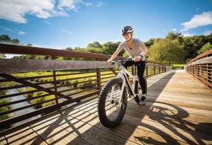 149 Woman Biking Across Bridge at CamRock County Park in Cambridge