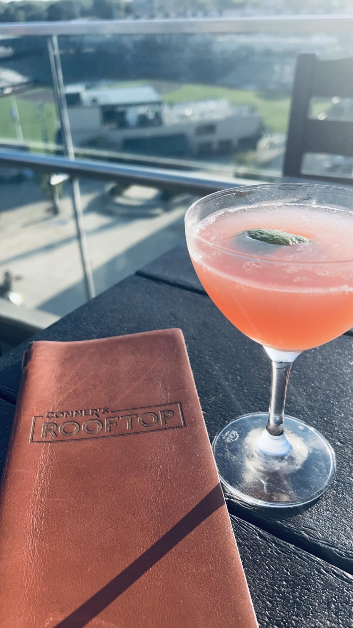 Cocktail from Conner's Rooftop and image of outdoor seating