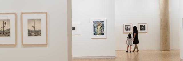 A mother and daughter observing art at the Eskenazi Museum of Art