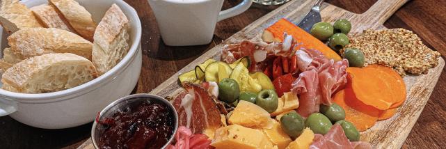 A charcuterie board, latte, and mojito from Feast Market & Cellar