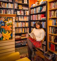 Picture of girl reading book at Mondragon books