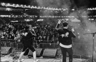 Singers perform in front of large crowd at Chukchansi Park in Fresno