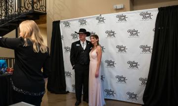 Rising Stars Gala attendees pose at photo booth.