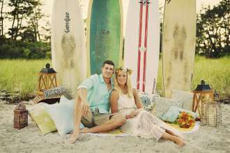 A couple celebrates their surfer wedding on the beach in South County, RI