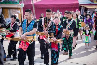 Hmong people playing instruments and celebrating