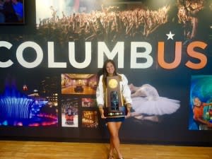 Nicki Meyer Dennis holding NCAA Volleyball Trophy