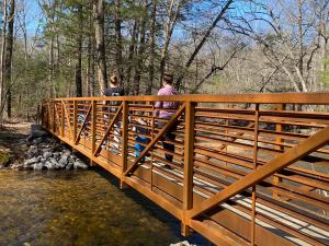 Family walking on the bridge at Pine Grove Furnace State Park