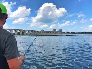 Man fishing next to a bridge on the Susquehanna River