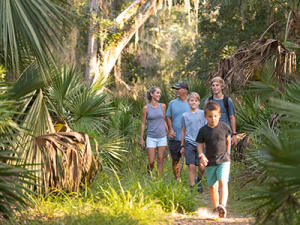 Smiling family enjoying a hiking trails in Daytona Beach