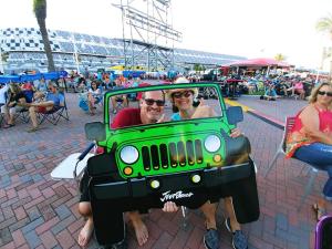 A couple enjoys a playful moment at Daytona International Speedway during Jeep Beach