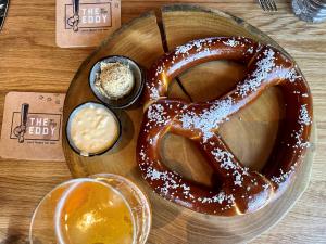 Large soft pretzel and dipping sauces at The Eddy Taproom & Hotel