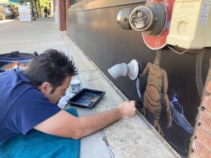 Man Painting A Mural At Itty Bitty Art Tour In Golden, CO