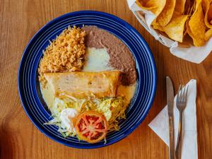 Entree Plate with rice and refried beans with chips on the side