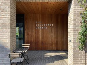 Wooden sign of the Gillespie Centre on the outside of the conference centre at Clare College Cambridge