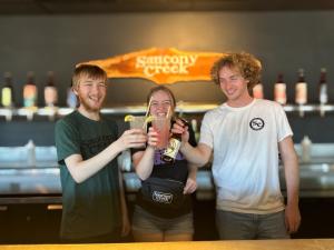 Three people giving cheers before having drinks