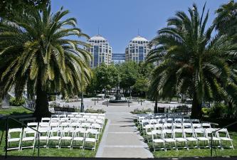Preservation Park's outdoor event venue seating between palm trees
