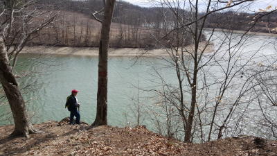 Man overlooks the water at blue marsh lake during winter