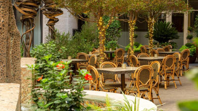 Outdoor restaurant patio with greenery