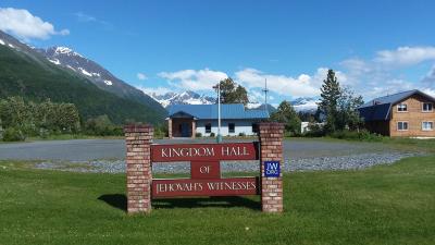 a Kingdom Hall of Jehovah's Witnesses in front of mountains