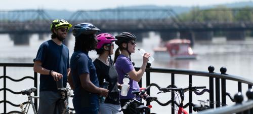 Bikers on Riverfront w Riverboat Background