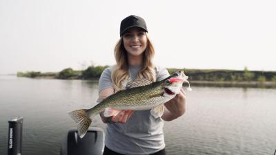 woman holding walleye from open water fishing on Devils Lake ND