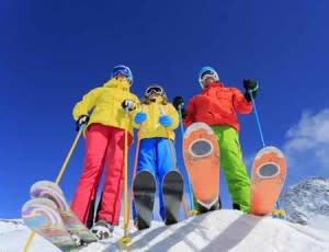 three skiers under bluebird skies | shutterstock