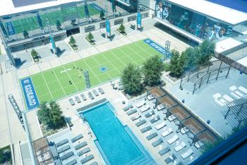 aerial shot looking down at Omni Frisco Hotel pool and Tostitos Championship Plaza