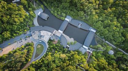 Aerial view of Crystal Bridges Museum of American Art surrounded by bright green trees