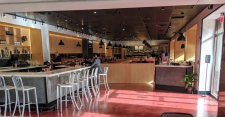 photo of sun shining in a window of the entrance of a restaurant