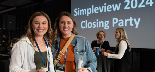 two women enjoying Summit closing party