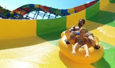 Father and daughter zooming down a waterslide at Daytona Lagoon Waterpark and Family Entertainment Center