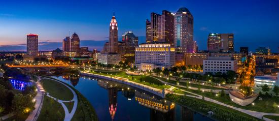 Downtown skyline with Hotel LeVeque by Marriott lit up at dusk.