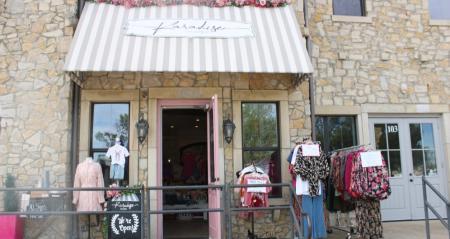 Karadise boutique entrance with clothing on mannequins