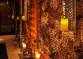 A dimly lit lobby lounge with ornate decor and candlelight