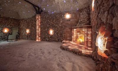 Beautiful Salt Cave built with Himalayan Salt bricks illuminated with fairy lights, glowing salt crystals and a faux fireplace made with glowing salt blocks.