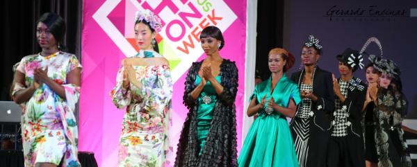 Models in designer clothes walking runway and clapping during Columbus Fashion Week fashion show