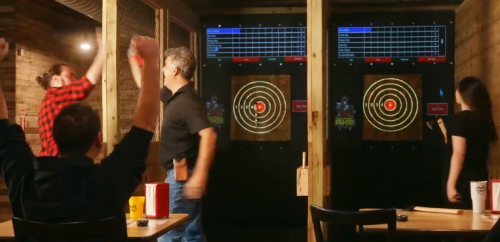 Guys high 5ing after throwing an axe