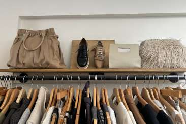 A shelf and clothing rack full of unique vintage finds in a vintage store in Oakland.