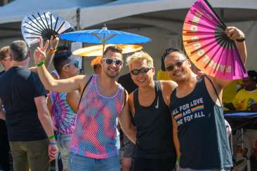 Three friends having a great time at pride parade and festival in oakland california