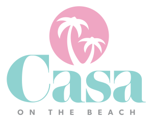 Pink and blue logo reads "Casa on the Beach" The outline of a pair of palm trees sits in a pink circle. Underneath, the word "Casa" is large in a light teal color. Light gray under that text that says "On the Beach"