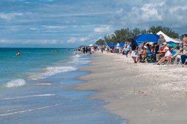 Group of people on the beach watching the Offshore PowerBoat Association (OPA) racing at Englewood Beach Waterfest